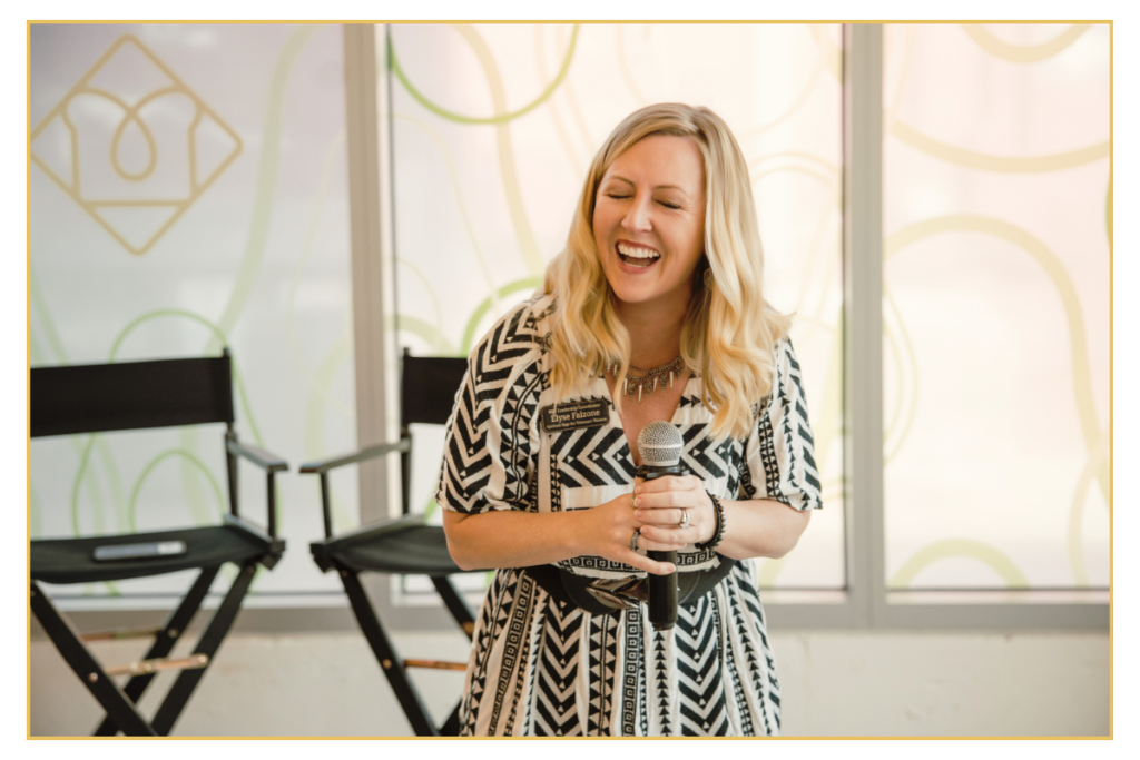 keynote speaker Elyse Falzone hold microphone during talk